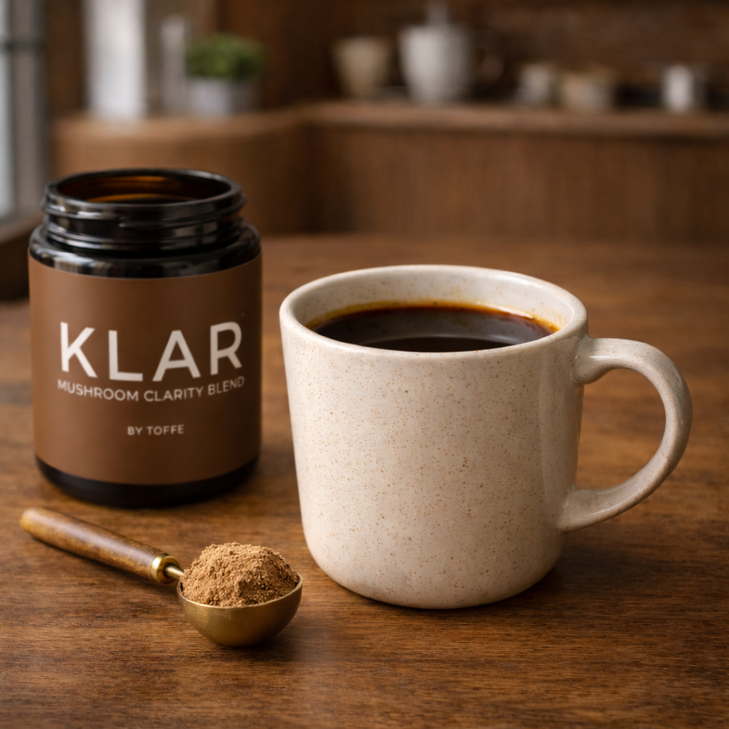 TÓFFE KLAR mushroom blend jar with coffee and measuring spoon for mental clarity and steady energy.